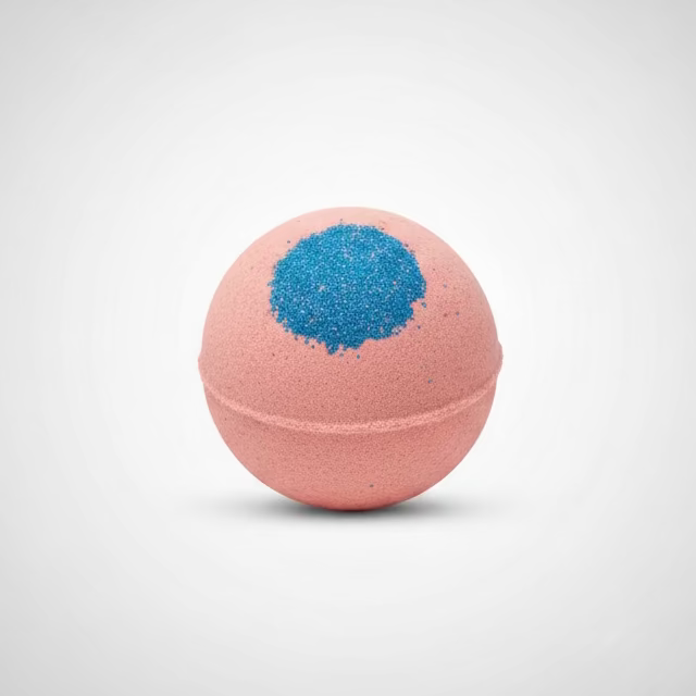Pink bath bombs with blue glitter on a white surface with decorative elements.