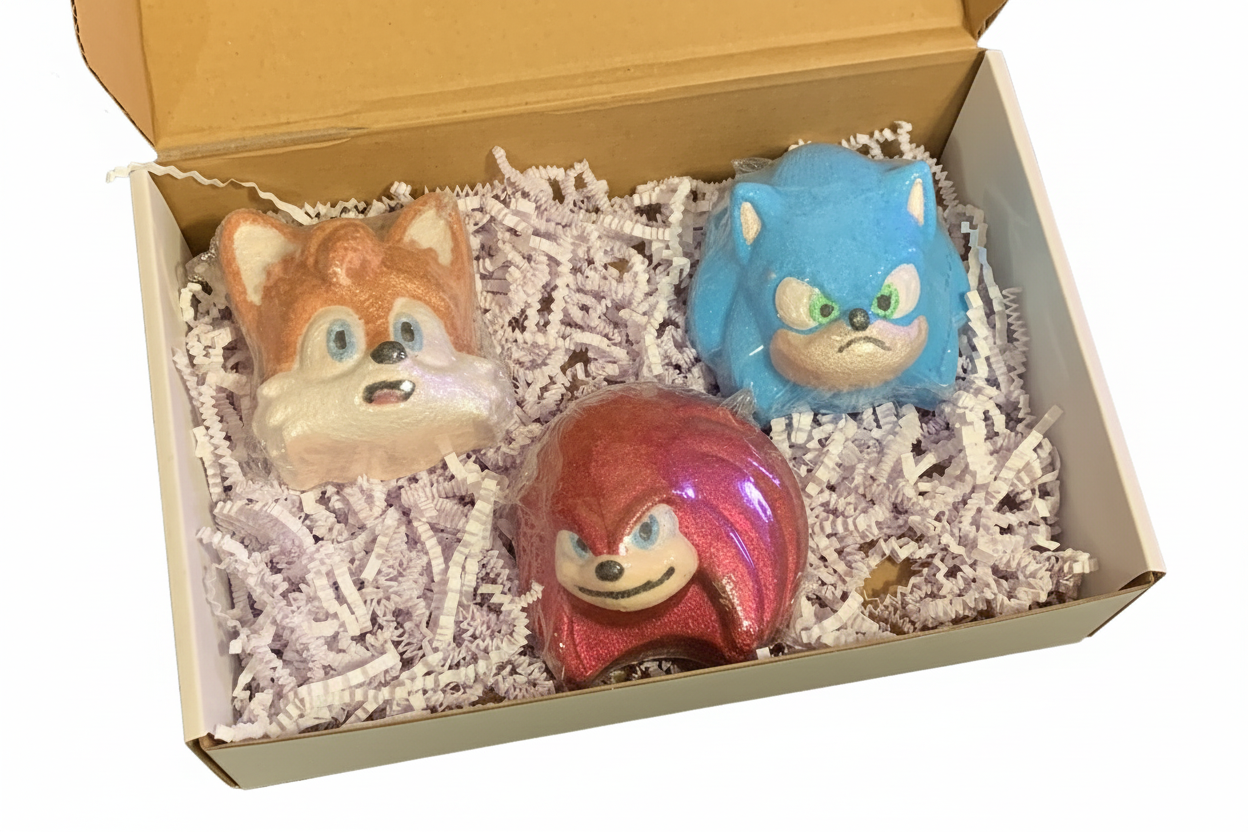 Three colorful sonic figurines in a box with shredded paper